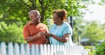 happy-older-couple-outside-in-front-of-picket-fence_573x300.jpg